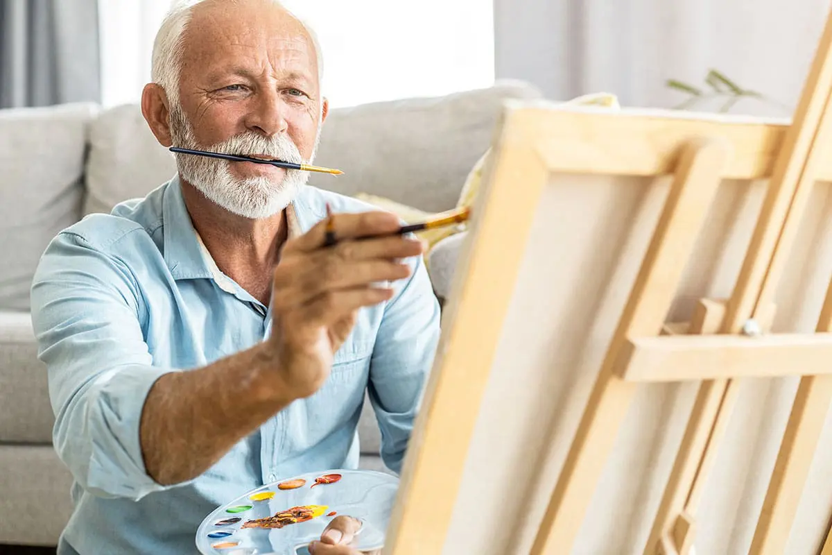 iStock-1267233046_1200x800 Senior man painting on a canvas