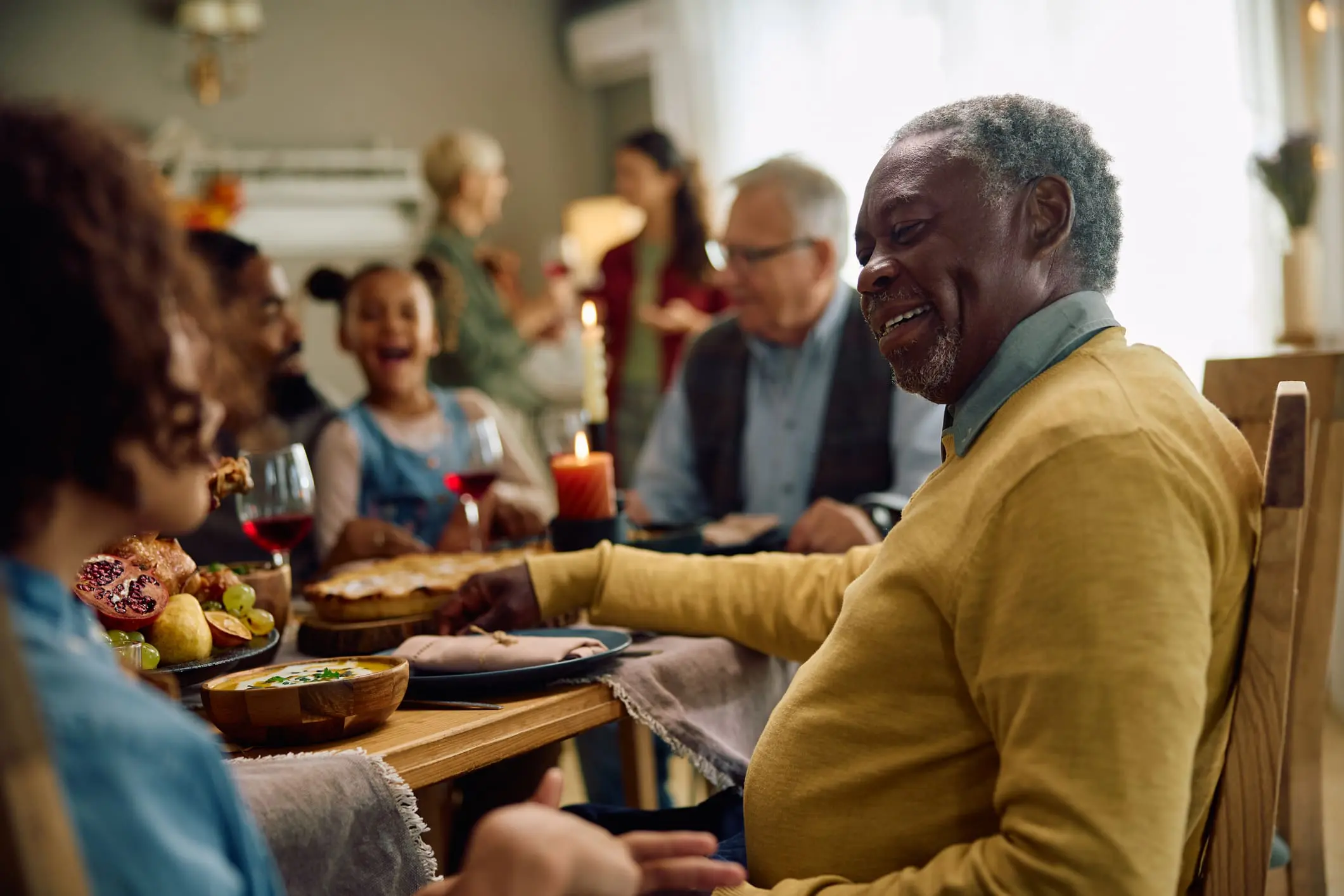 senior man at family gathering while discussing signs it's time for Independent Living at Canterbury Woods Gates Circle.