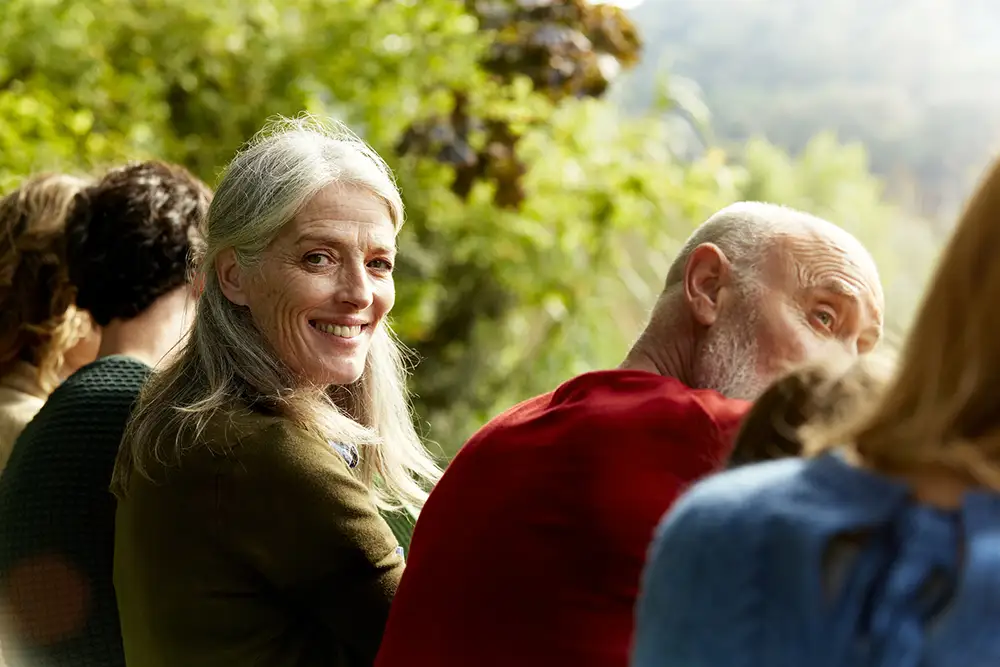 Senior woman sitting with family at park