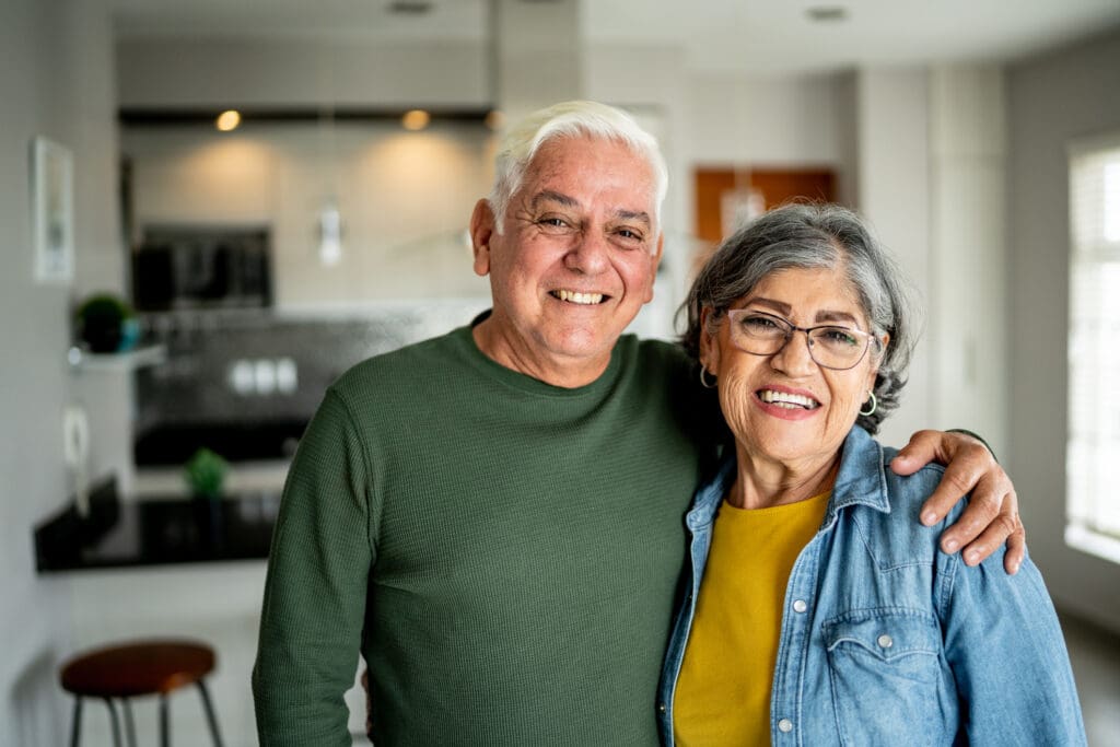 Senior couple smiling in the room
